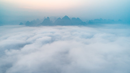 aerial view of cloudscape above roll of hills at dawn