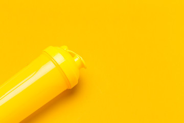 Yellow plastic protein shaker on vibrant background