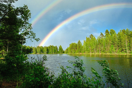 Beautiful Colorful Rainbow Over The Lake