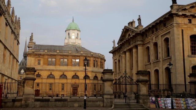 Pan right from Bodleian Library via Sheldonian Theatre and back of Clarendon Building POV from Queen's Lane across Catte Street at the golden hour