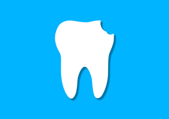 White Tooth with pronounced damage from caries cut from a colored paper on a blue background. Handmade. The concept of dental care and dentistry. Flat lay, top view