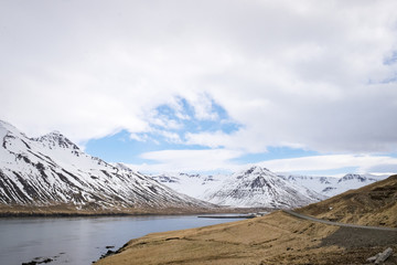 A fjord view with a road and mountains in Iceland