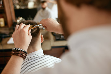 Obraz na płótnie Canvas Men Haircut. Barber Cutting Man's Hair In Barber Shop 