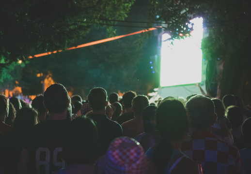 Football fans in fanzone watching football.