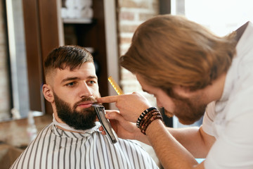 Barber Shop. Man Gets Beard Hair Cut