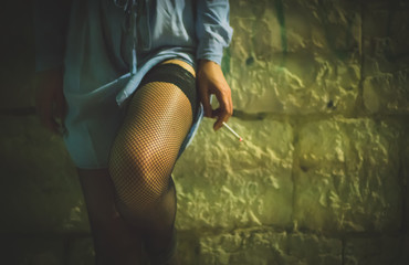 Prostitute with cigarette working on the night street.