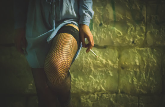 Prostitute with cigarette working on the night street.