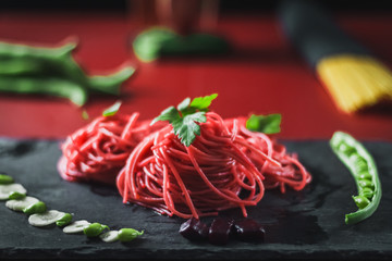 red spaghetti with beetroot and green beans