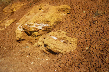the surface texture of the slope from dry sand-clay granular soils with a reddish tinge