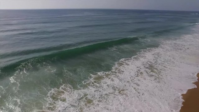 Flying over a sufer at the beach from moliets-et-maa
