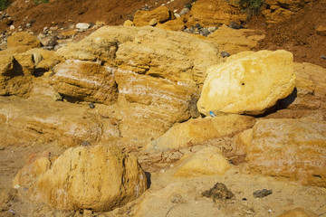 the surface texture of the slope from dry sand-clay granular soils with a reddish tinge
