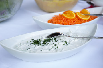 raditional greek dip sauce or dressing tzatziki prepared with grated cucumber sour cream yogurt olive oil and fresh parsley