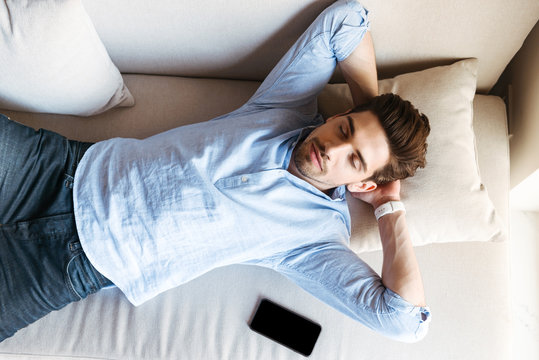 Top View Of A Young Man Sleeping On The Couch