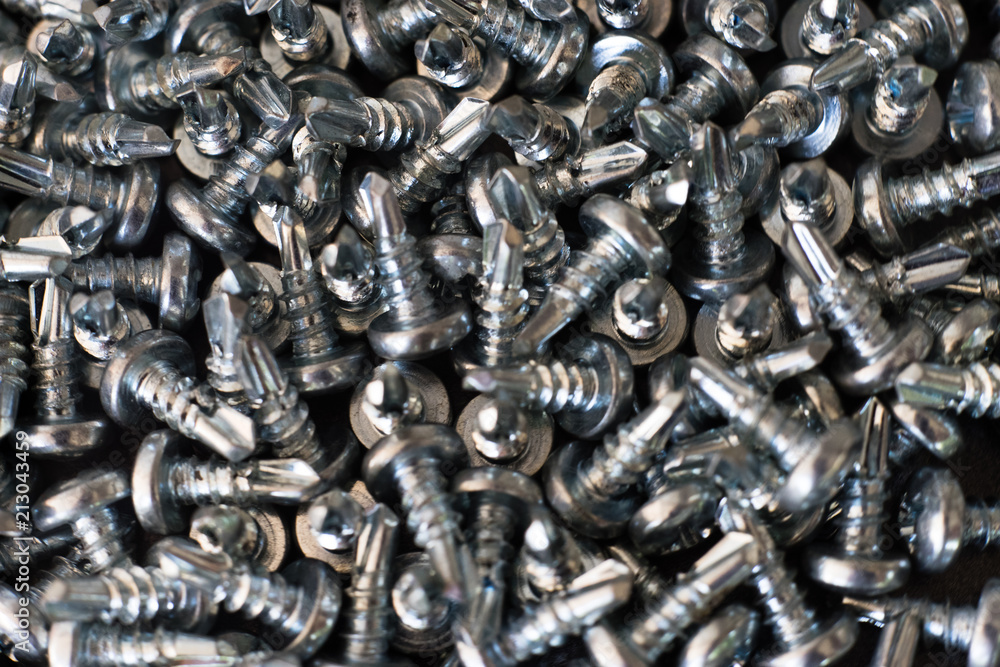 Poster screws on a metal table macro.