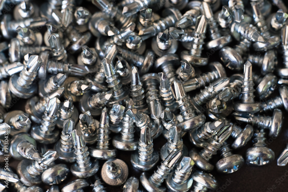 Poster screws on a metal table macro.