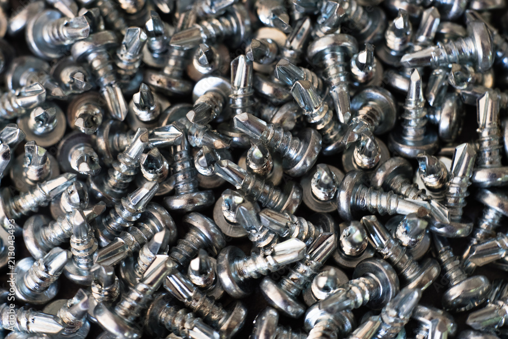 Poster screws on a metal table macro.