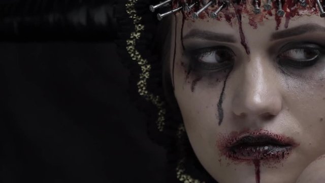 A sad demoness with horns on her head