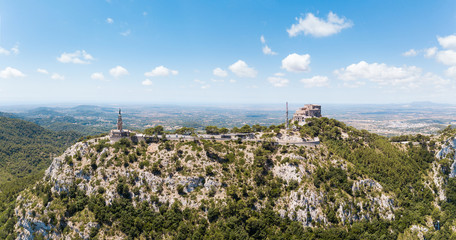 Fototapeta na wymiar Aerial: The old benedictine monastery on the Saint Salvador mountain in Mallorca, Spain