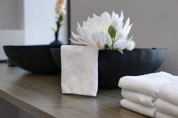 beauty salon table close-up with flower decoration in a spa room and white towels