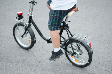 Fototapeta premium child on a bicycle at asphalt road.