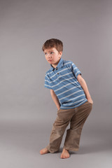 Portrait of little boy on gray backgraund