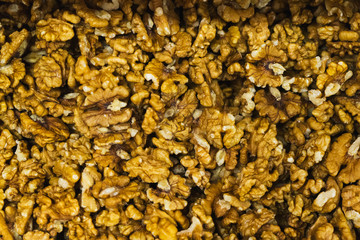 Peeled walnuts without shell, close-up top view  on the counter of the vegetable market. 