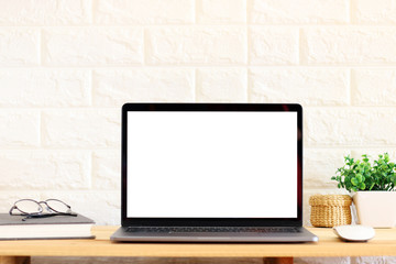 Fototapeta premium Blank screen Laptop on wooden table at home Office