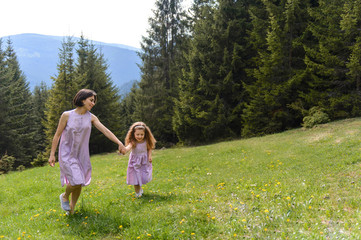 Obraz premium Mother and Daughter Walking at Forest
