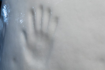 Prints of a human hand on a block of ice. handprint of the passage of man on a glacier.
