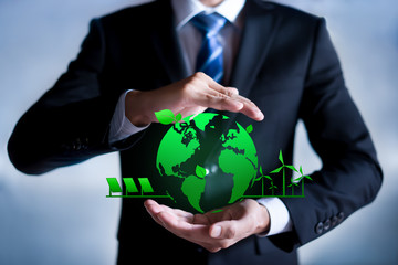 Businessman with a green globe. eco-friendly business. Business and environmental concepts