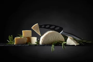 Fotobehang Sheep cheese with rosemary on a black background. © Igor Normann