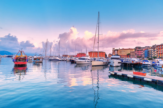 Santa Margherita Ligure, Italy, Rapallo region. Amazing sunset scenery with dramatic sky and boats and yachts at foreground. Romantic Luxury coastal resort in Ligure rivera in Italy. Ligurian sea.