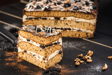 Sweet cake with layers on black background