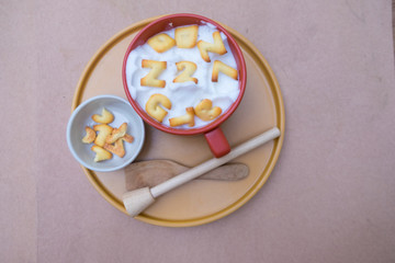 A cup of hot milk with biscuit