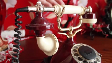 removes the white tube from the red phone and puts it back, ignores the call - Powered by Adobe