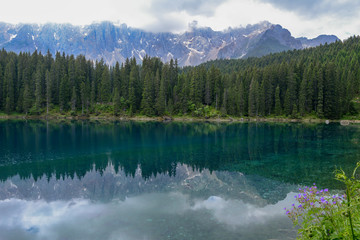 Lake Carezza with reflection of mountains in the Dolomites