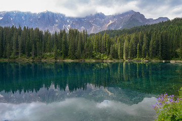 Lake Carezza with reflection of mountains in the Dolomites