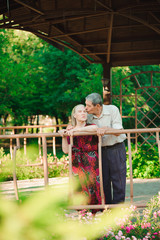 Happy old couple in a park on a sunny day