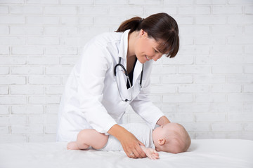 portrait of female doctor pediatrician with little baby patient © Di Studio
