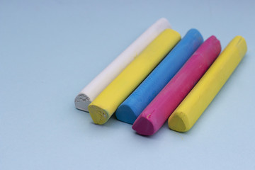 Multicolored crayons on a blue background, isolated