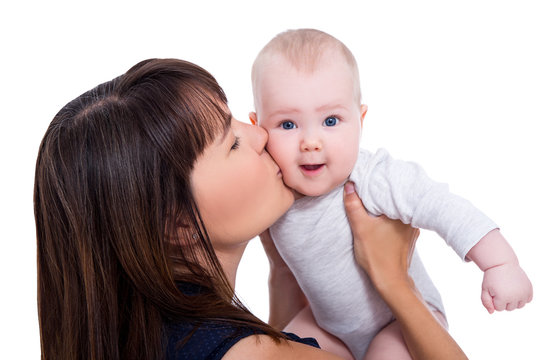 close up portrait of beautiful young mother kissing little baby isolated on white