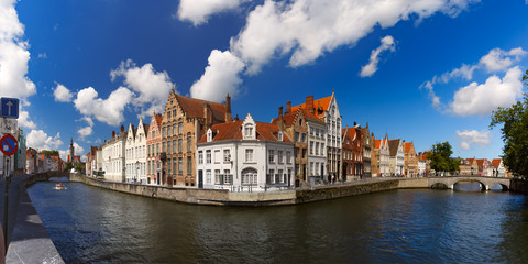 Canal Spiegelrei, bridges and tourist boat on the sunny morning in Bruges, Belgium