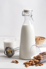 Almond milk on a white wooden table