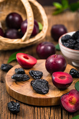 Dried Plums Pitted Prunes and Fresh Plums Background. Selective focus.