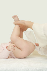 Fototapeta na wymiar Newborn baby getting a diaper change: mom wiping baby's bottom with baby wipe