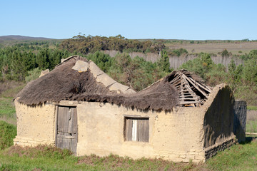 Abandoned, derelict building in rural farmland
