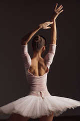 Fototapeta premium Young beautiful ballerina is posing in studio