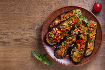 Pan fried eggplants with tomatoes, paprika, carrot, onion and garlic. View from above, top studio shot