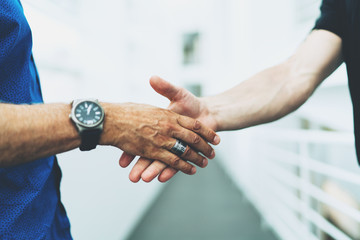 Closeup photo of two successful entrepreneurs shaking hands as a sign of productive partnership on a project. Professional marketing specialist received a job offer after applying for a job