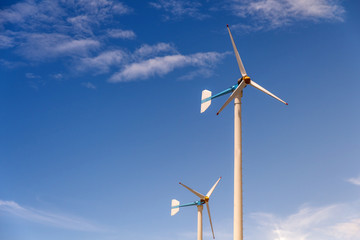 Fototapeta premium Wind turbine generating electricity on blue sky with clounds,Windmills for electric power ecology concept